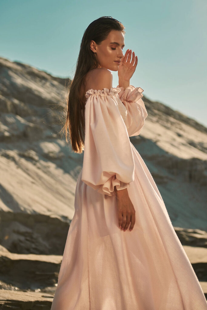 Pale pink dress in blue polka dot print with puffy sleeves, midi length