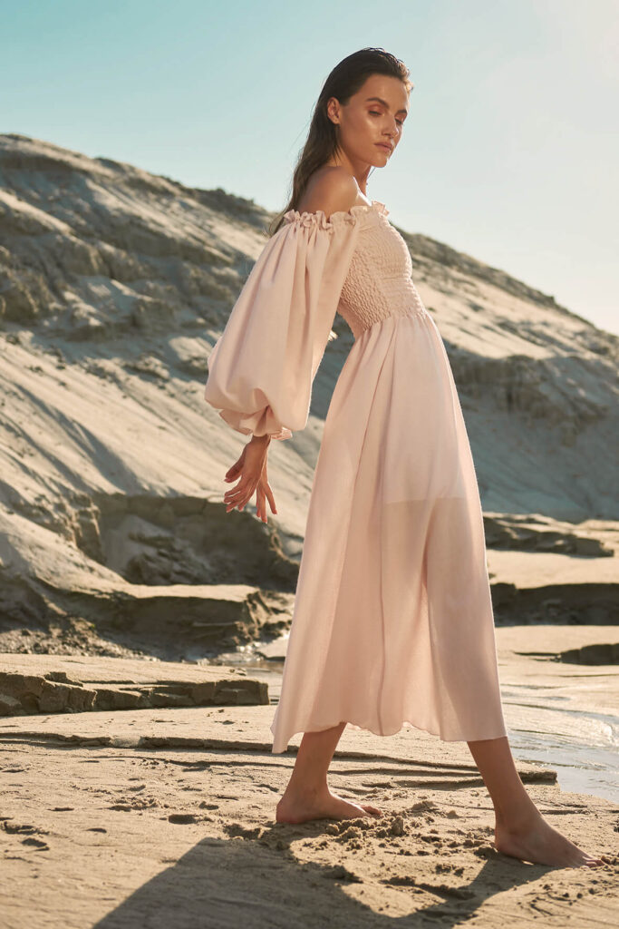 Pale pink dress in blue polka dot print with puffy sleeves, midi length