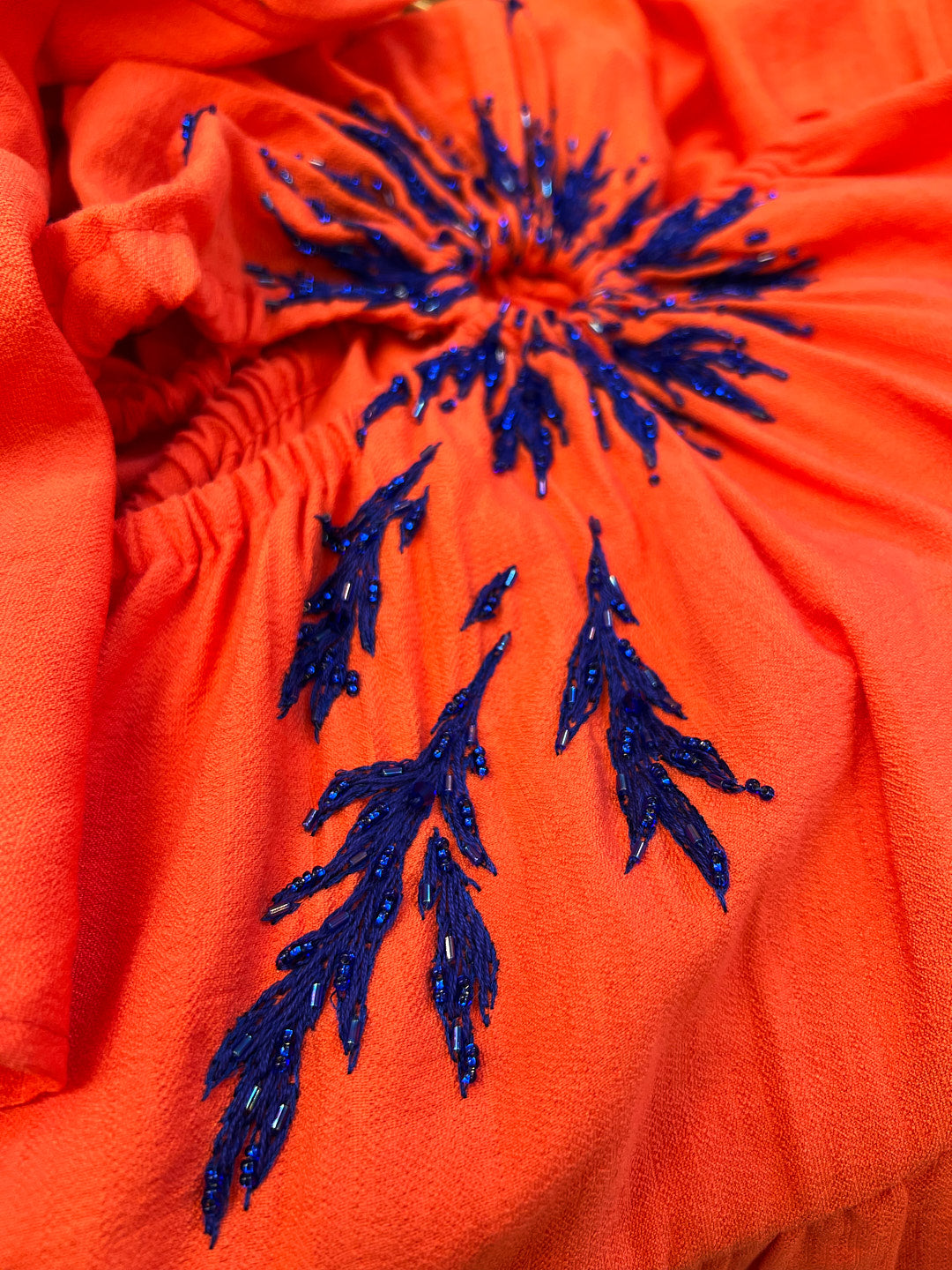 Orange dress with hand-made embroidery.