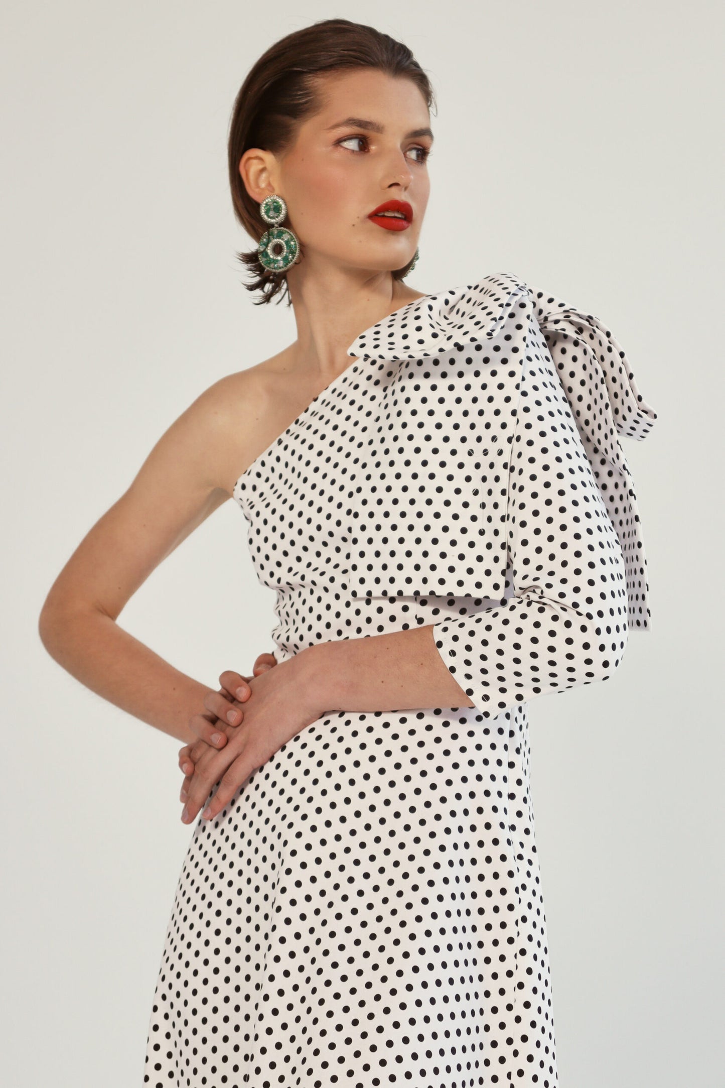 One-shoulder polka dot dress with a bow